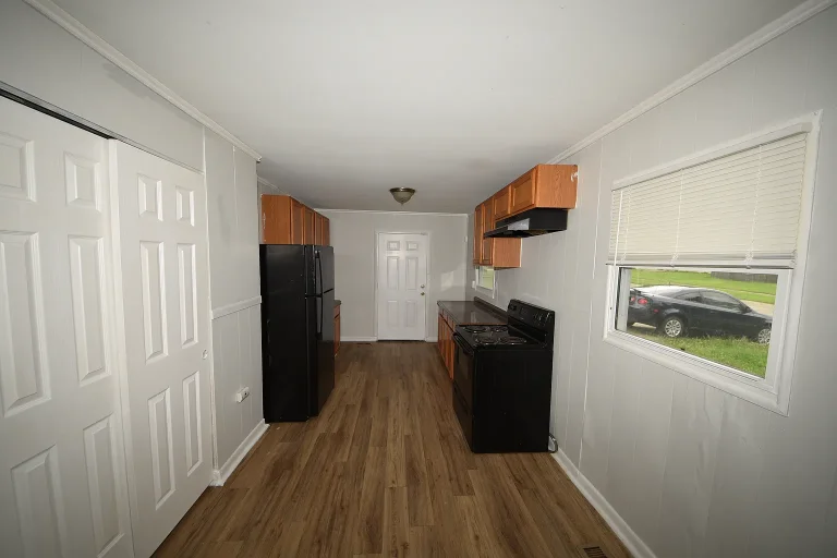 Kitchen entry with double doors and black appliances