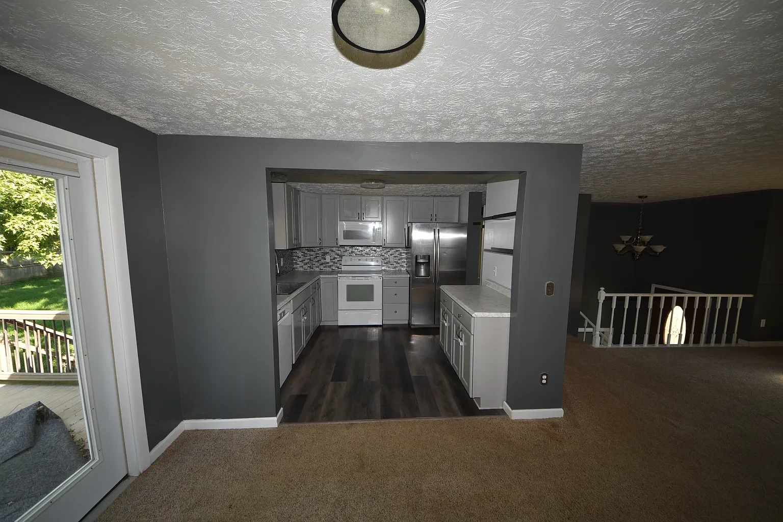 Dining area facing kitchen and sliding patio door