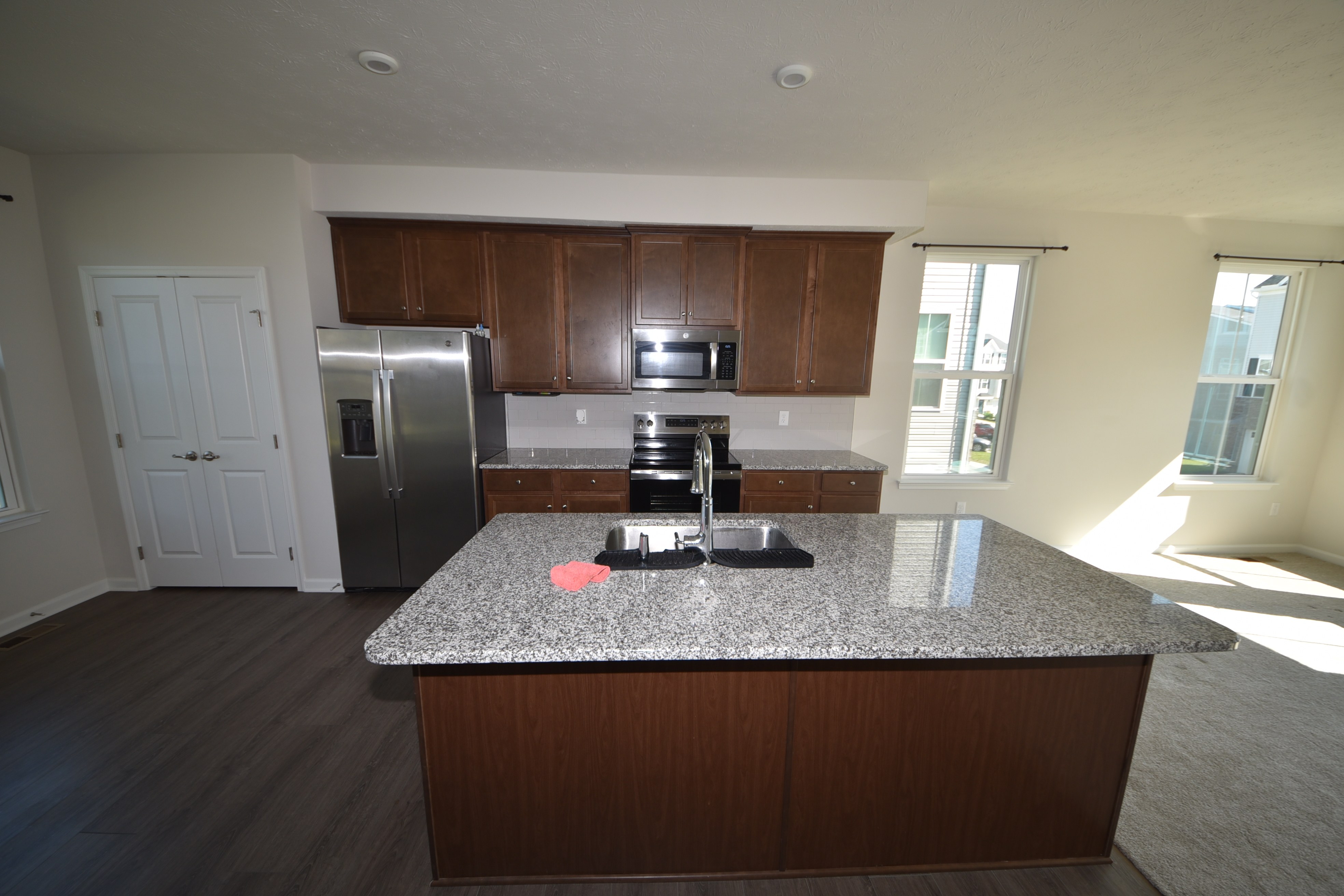 Kitchen with granite island and stainless steel appliances