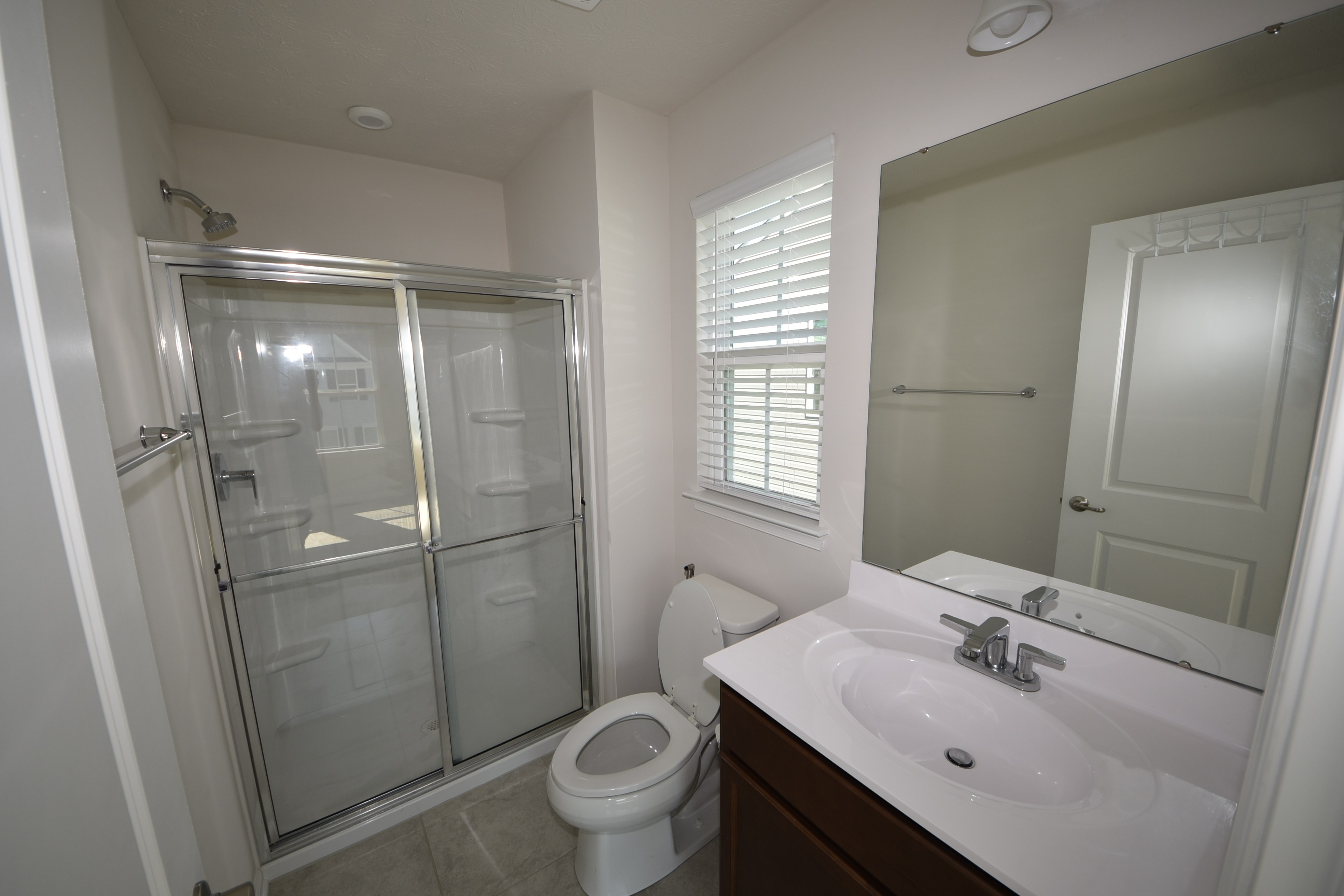 Primary bedroom with tray ceiling and bathroom doorway