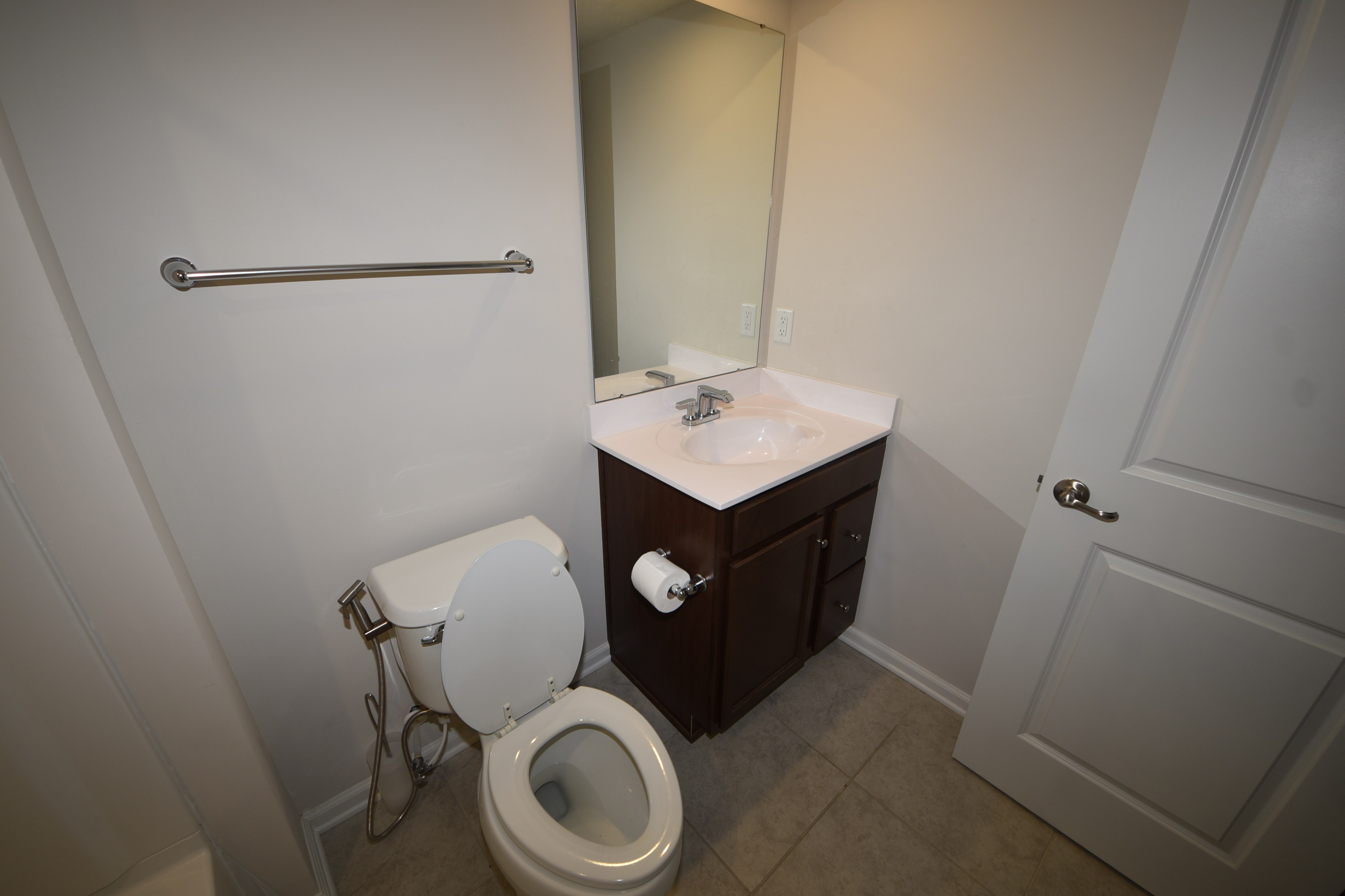 Half bathroom with vanity and mirror
