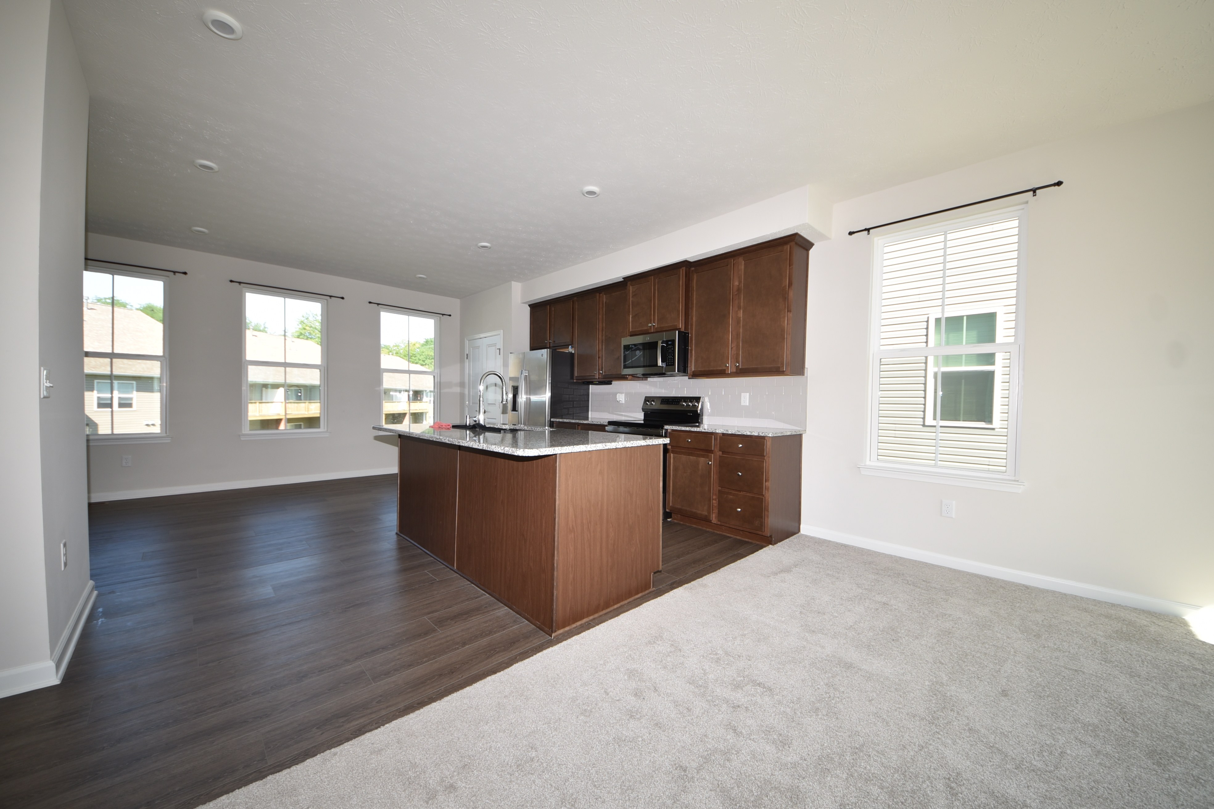 Open living and kitchen area with granite island