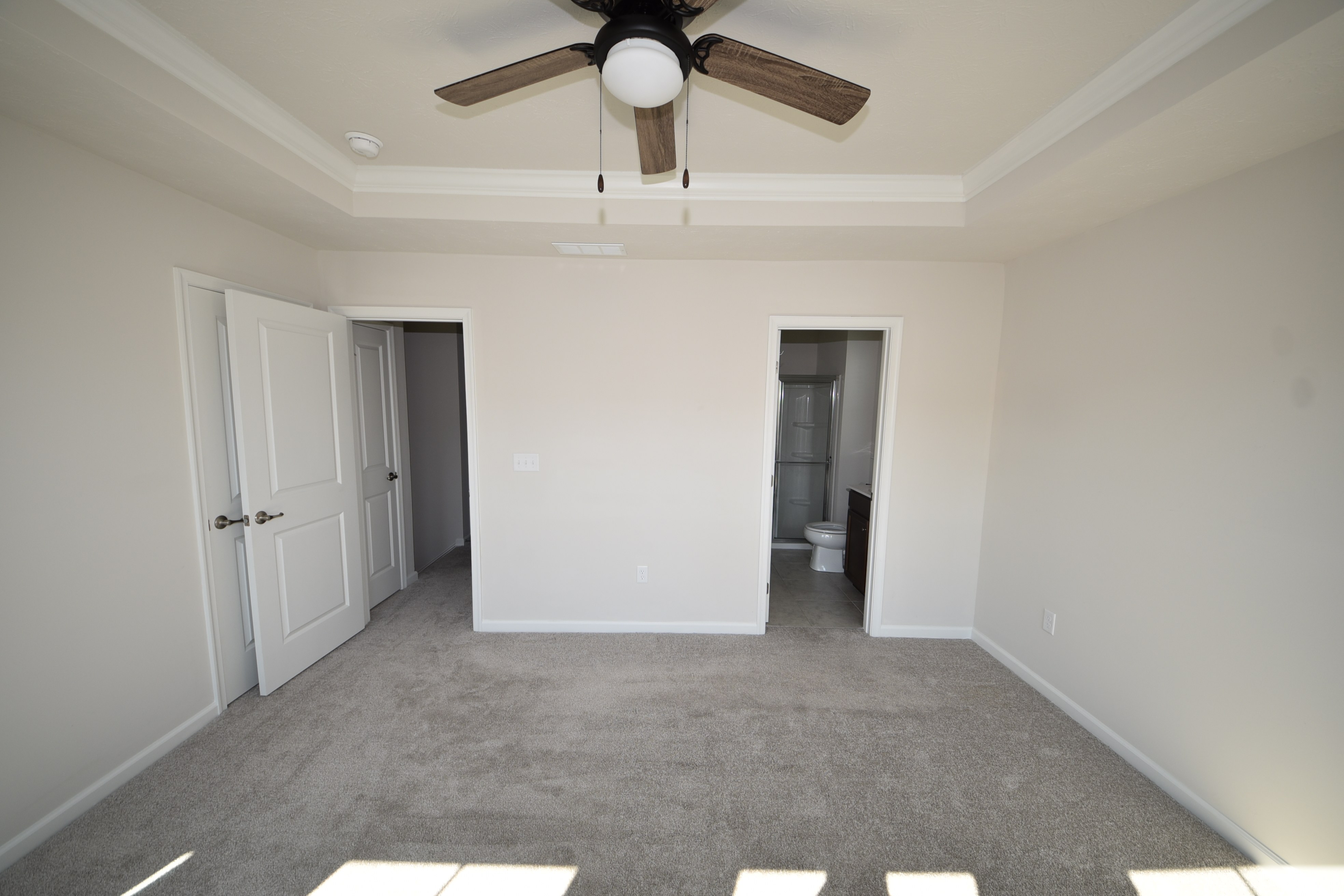 Primary bedroom with large windows and en-suite bath